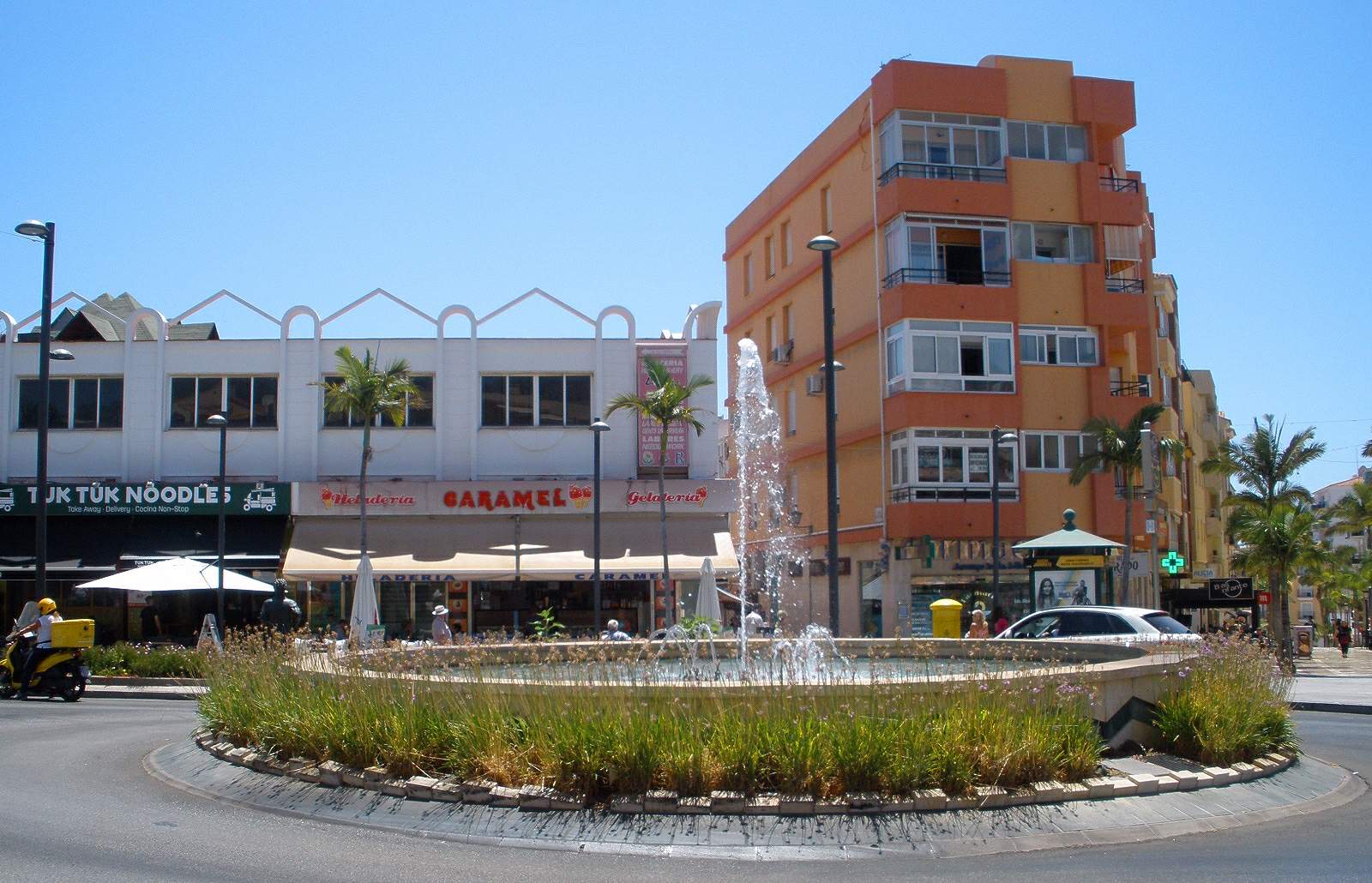 Roundabout with a fountain and shops in the centre of Arroyo de la Miel